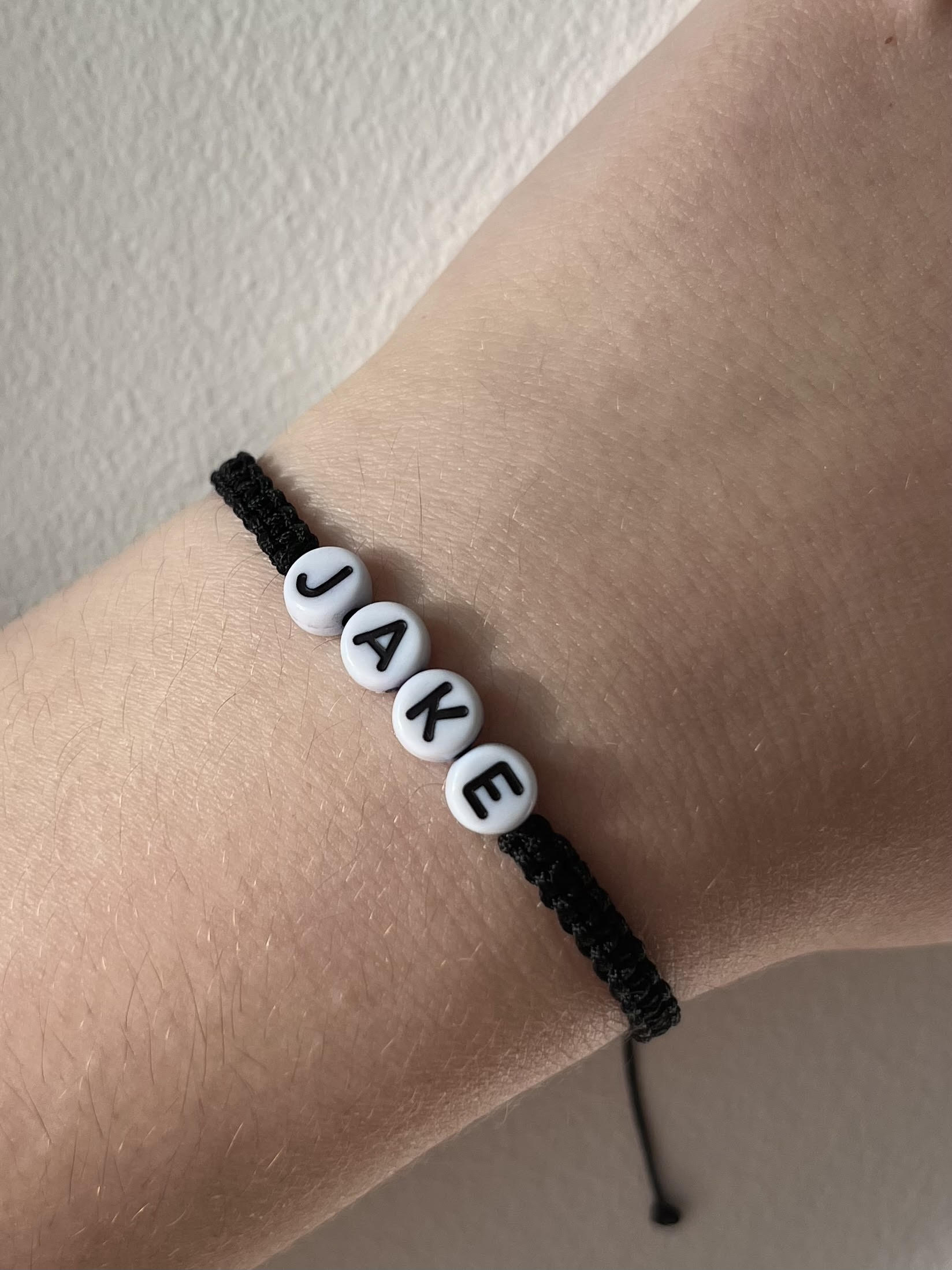 Black string bracelet name